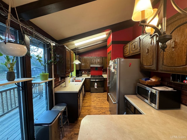 kitchen with vaulted ceiling with beams, dark brown cabinetry, hardwood / wood-style flooring, sink, and appliances with stainless steel finishes