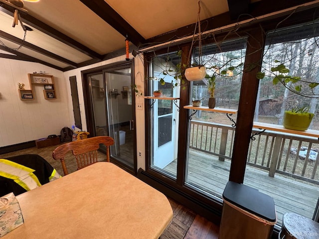 sunroom with vaulted ceiling with beams