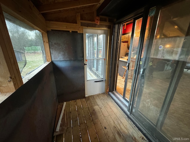 unfurnished sunroom with a wealth of natural light and lofted ceiling with beams