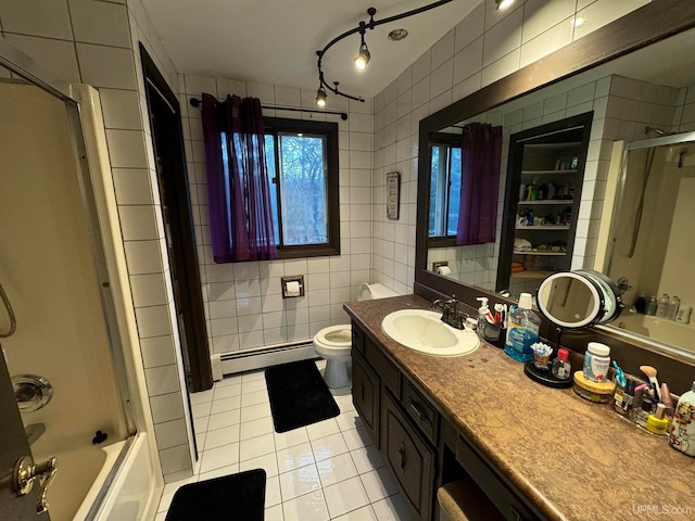 full bathroom featuring bath / shower combo with glass door, tile walls, tile patterned flooring, and baseboard heating