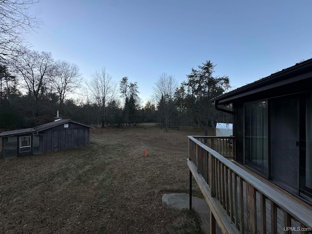 yard at dusk featuring a shed