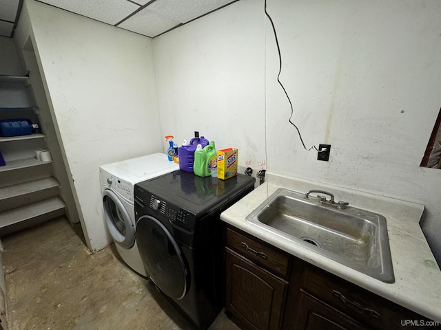 washroom featuring washing machine and dryer and sink