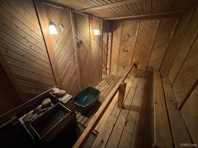 view of sauna with hardwood / wood-style floors, wooden walls, and wooden ceiling