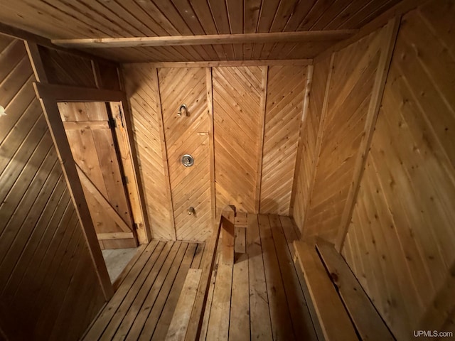 view of sauna with wooden walls