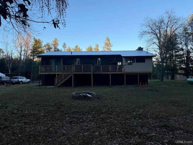 back of property with a yard and a deck