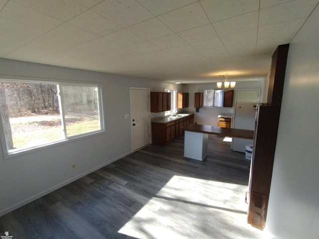 kitchen with pendant lighting and dark hardwood / wood-style flooring