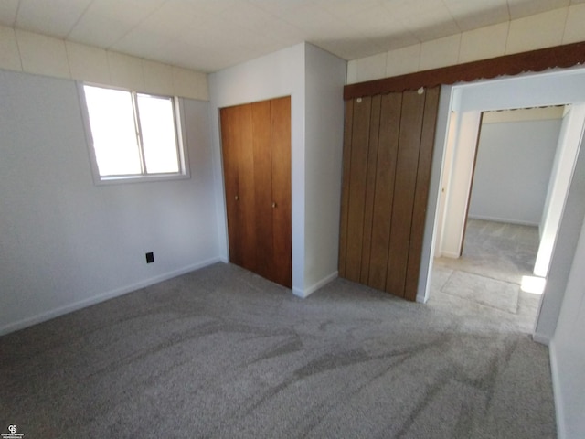 unfurnished bedroom with light colored carpet