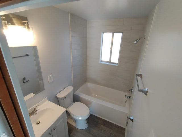 full bathroom featuring hardwood / wood-style floors, vanity, toilet, and tiled shower / bath combo