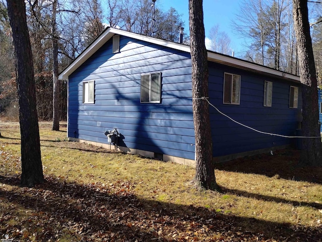 view of property exterior featuring a lawn