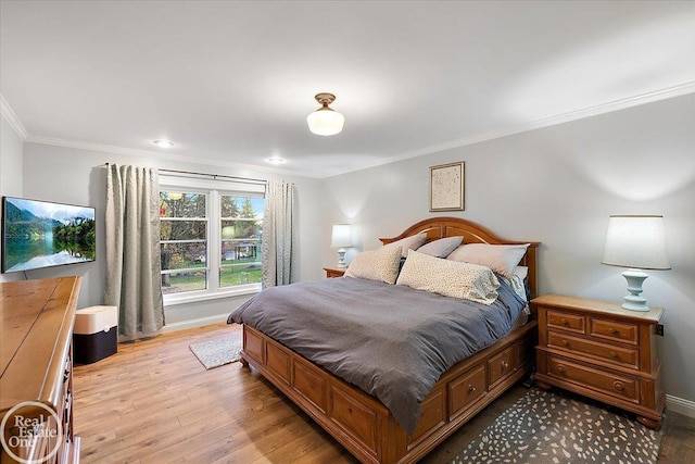 bedroom with light hardwood / wood-style flooring and crown molding