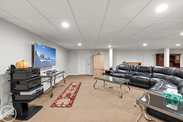 living room with carpet floors and a drop ceiling