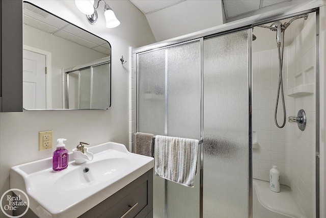 bathroom with vanity and a shower with door