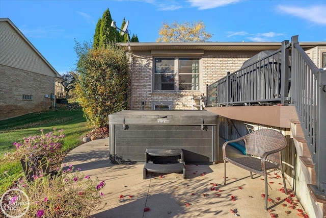 exterior space with a patio and a hot tub