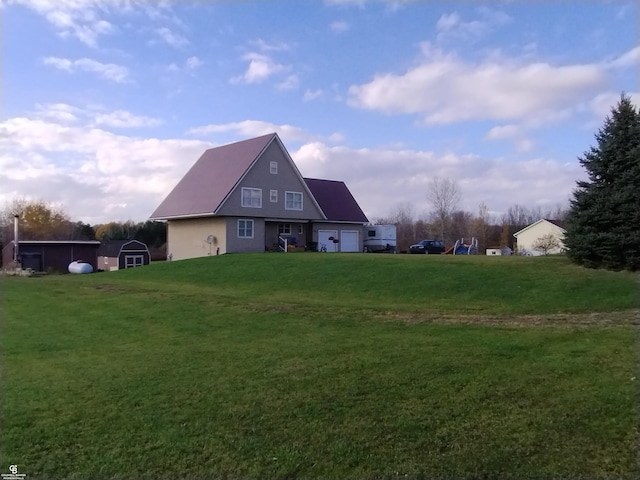 back of property featuring a storage unit and a yard