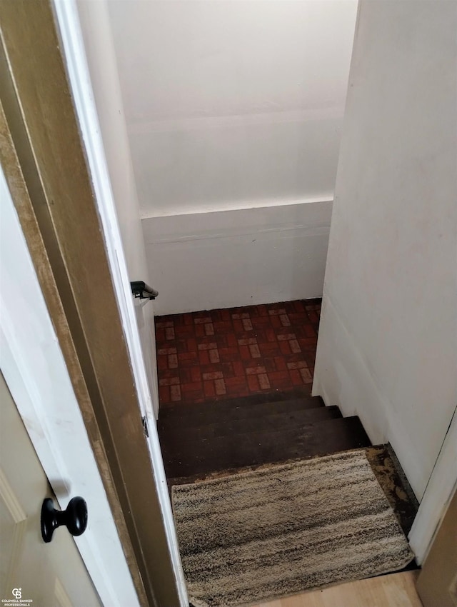 stairway with hardwood / wood-style floors