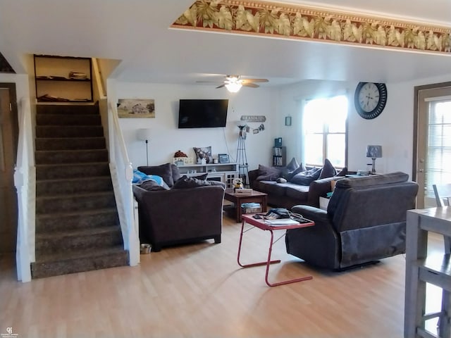 living room featuring hardwood / wood-style floors and ceiling fan