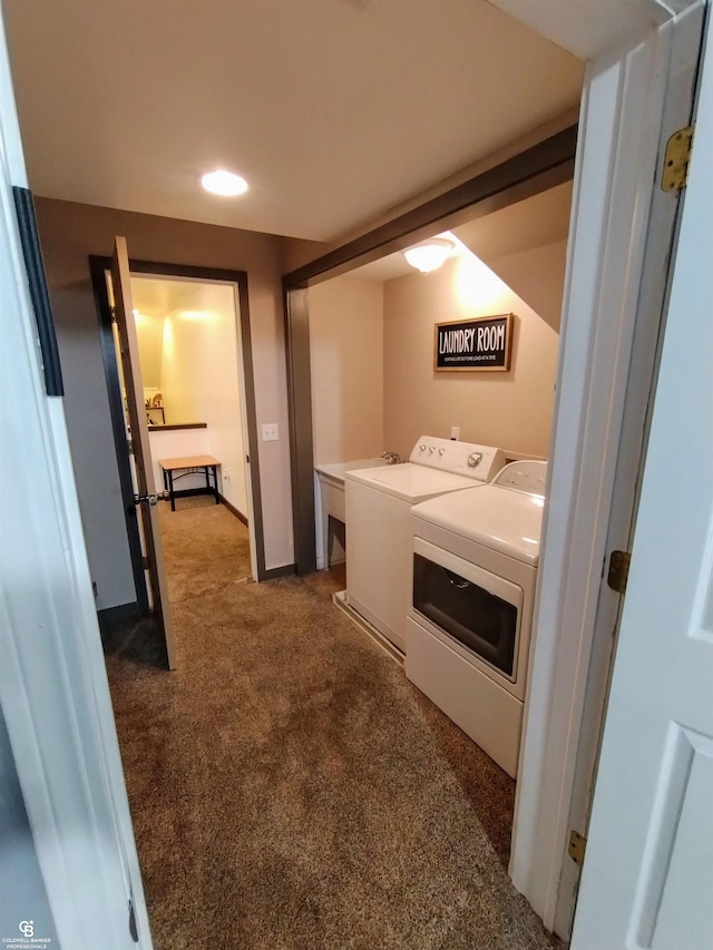 washroom with washing machine and dryer and dark carpet