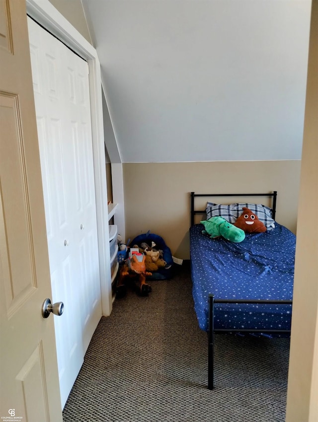 bedroom with a closet, carpet, and lofted ceiling