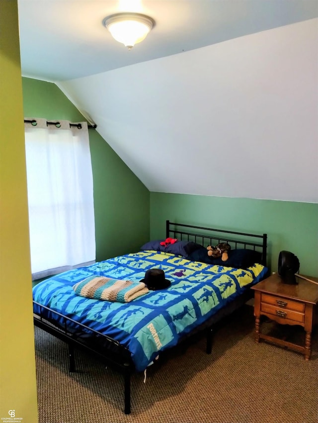 bedroom with carpet floors and vaulted ceiling