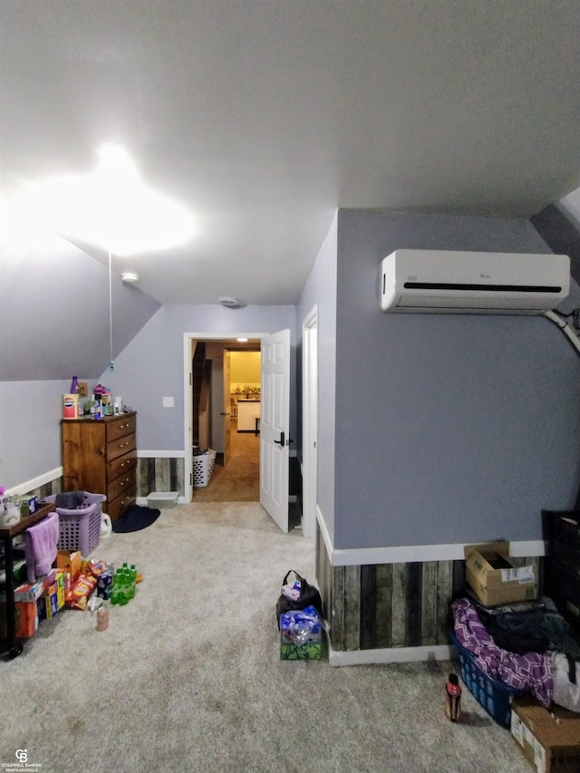 interior space featuring a wall mounted AC, light carpet, and vaulted ceiling