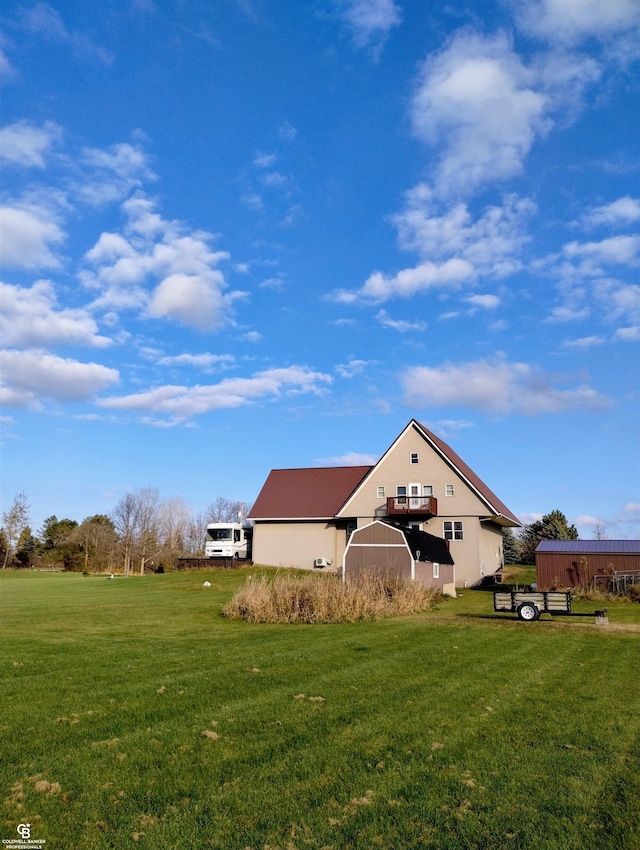 back of property with an outdoor structure and a yard