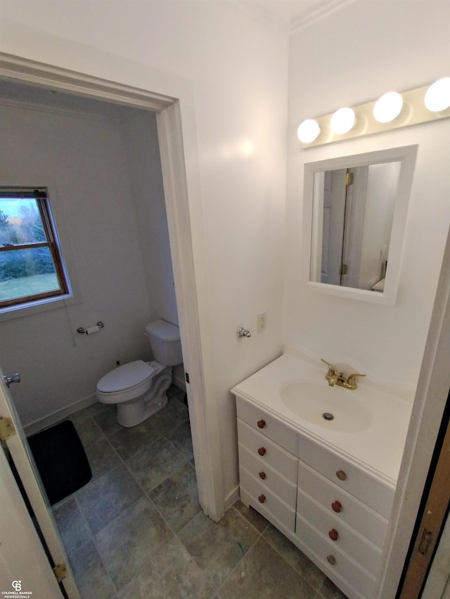 bathroom featuring vanity, tile patterned floors, and toilet