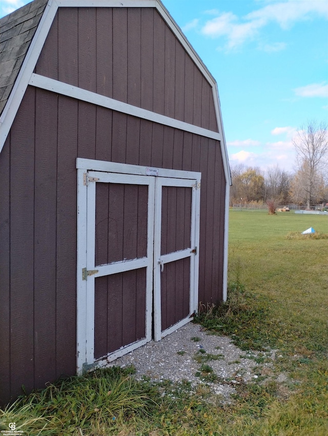 view of outbuilding with a yard