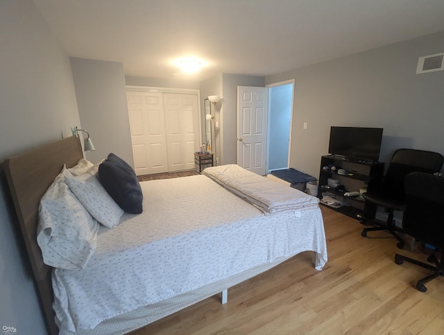 bedroom featuring wood-type flooring and a closet