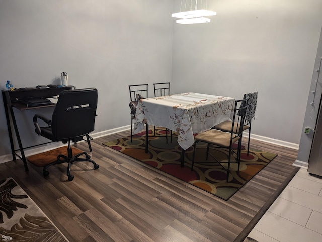 dining space with hardwood / wood-style floors