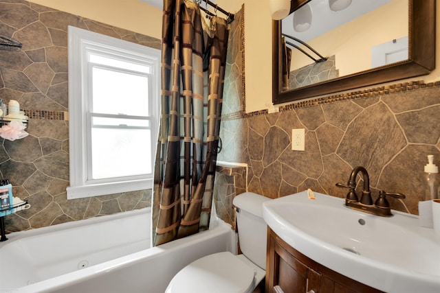 full bathroom with shower / bath combination with curtain, vanity, toilet, and tile walls