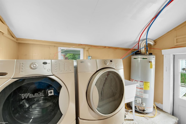 laundry room with washing machine and clothes dryer and gas water heater