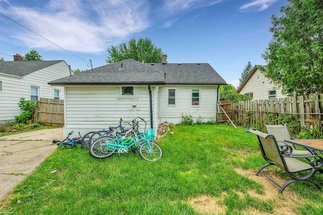 back of house with a yard