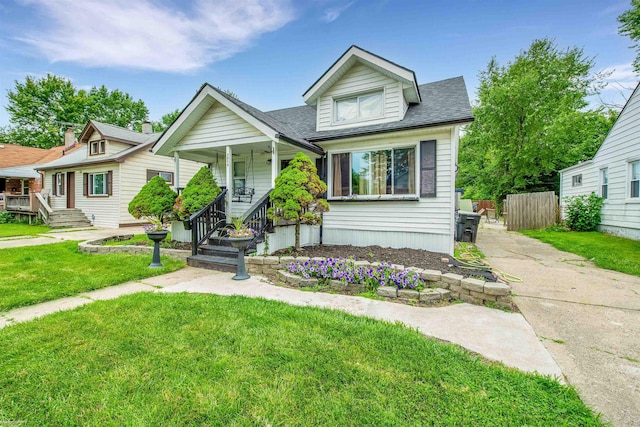 view of front of property featuring covered porch and a front lawn