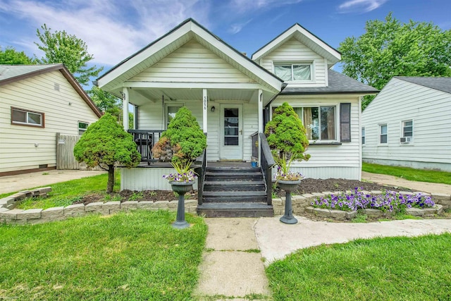 bungalow-style home featuring a porch and a front lawn