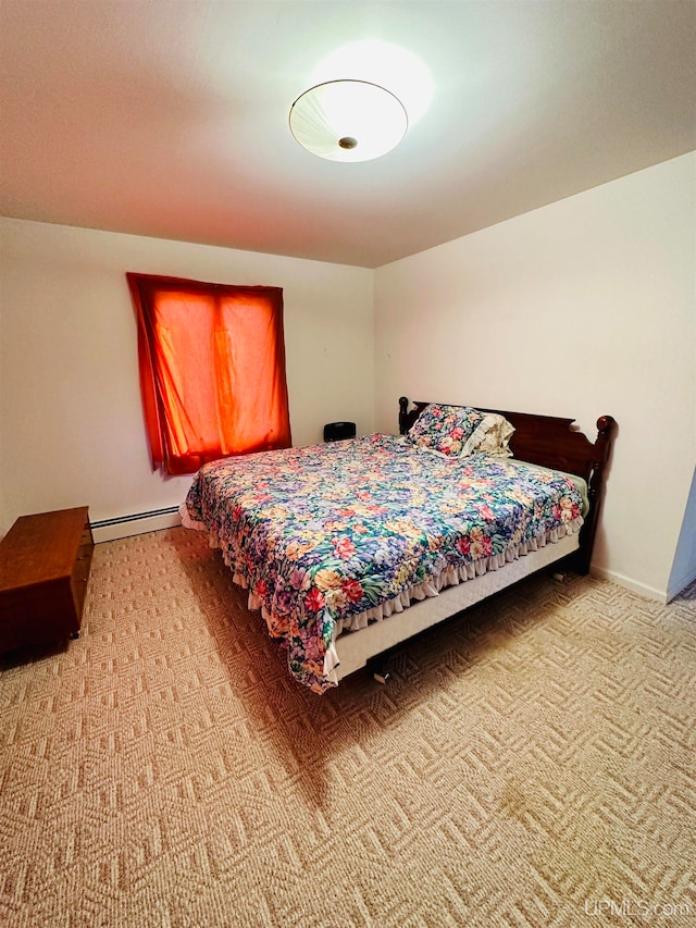 carpeted bedroom featuring a baseboard radiator