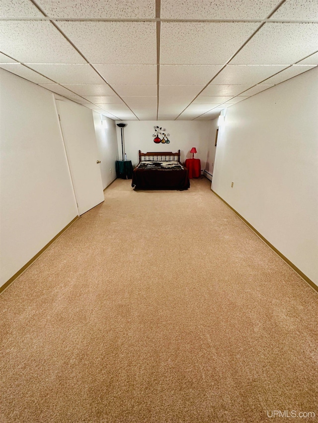 unfurnished bedroom with carpet and a paneled ceiling