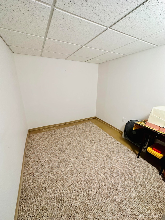 basement featuring carpet and a paneled ceiling