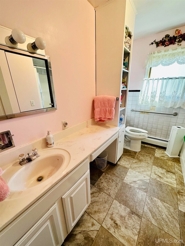 bathroom featuring vanity, toilet, and a baseboard heating unit