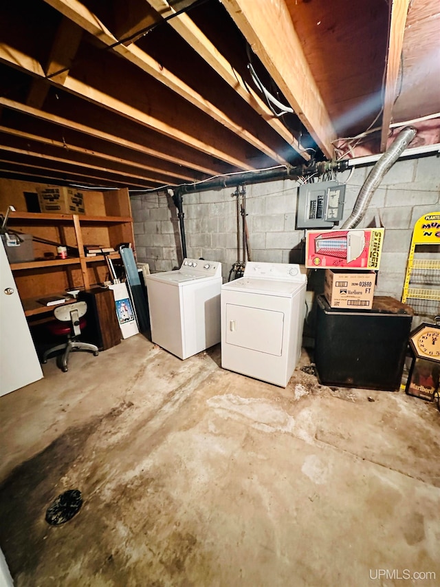 basement featuring electric panel and washer and dryer