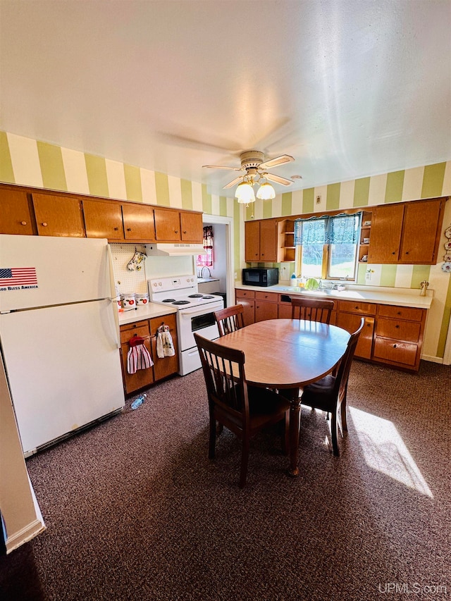 dining room featuring dark carpet and ceiling fan