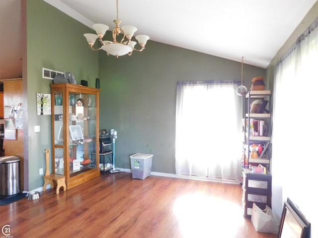 miscellaneous room featuring a chandelier, vaulted ceiling, and hardwood / wood-style flooring