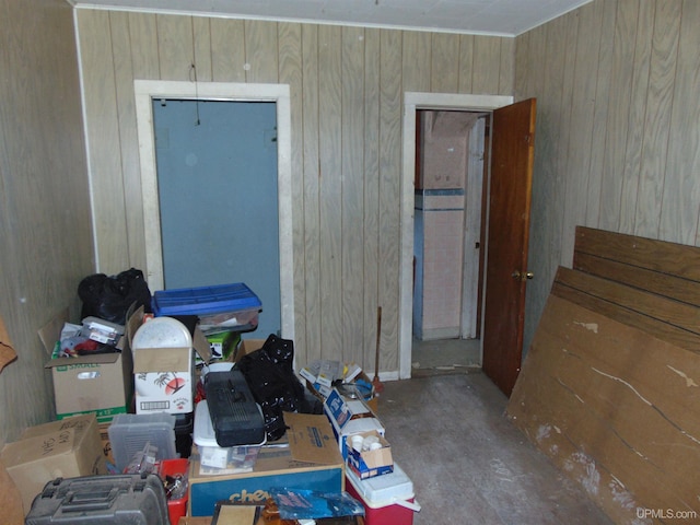 bedroom featuring wooden walls