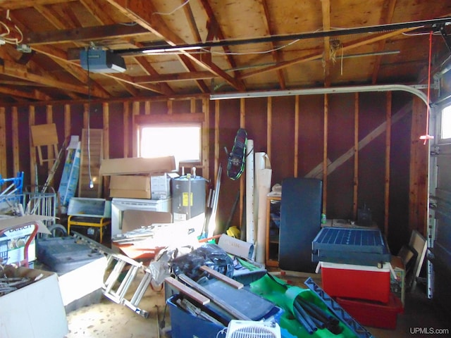 garage with a garage door opener and electric water heater