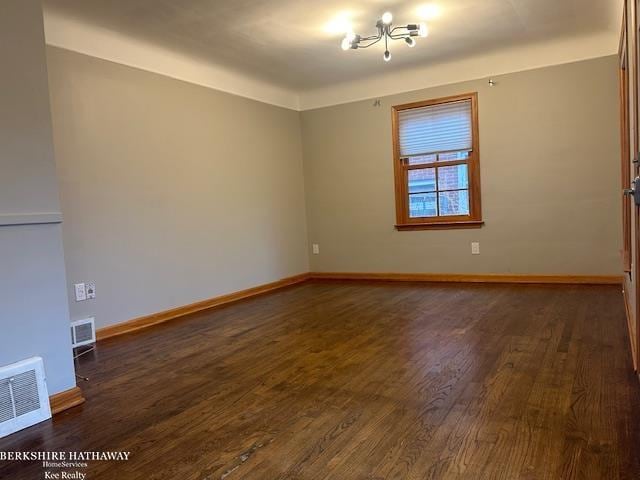 spare room with dark hardwood / wood-style flooring