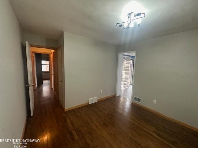 empty room featuring dark wood-type flooring