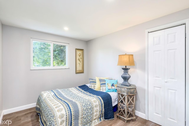 bedroom featuring hardwood / wood-style floors and a closet