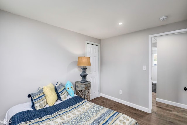 bedroom featuring dark hardwood / wood-style floors and a closet