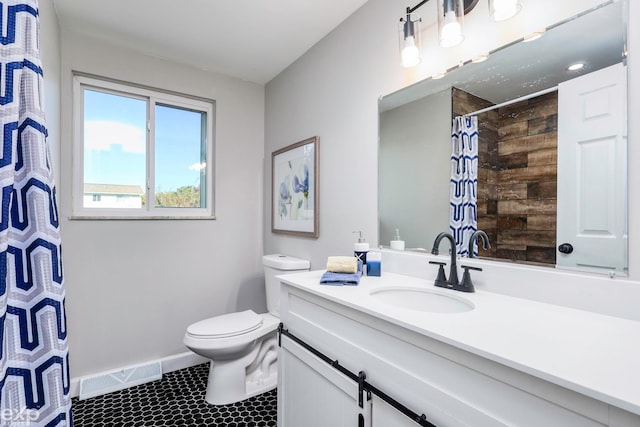 bathroom featuring toilet, a shower with curtain, vanity, and tile patterned floors