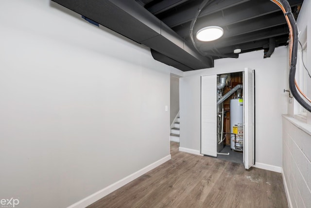 basement with wood-type flooring and gas water heater