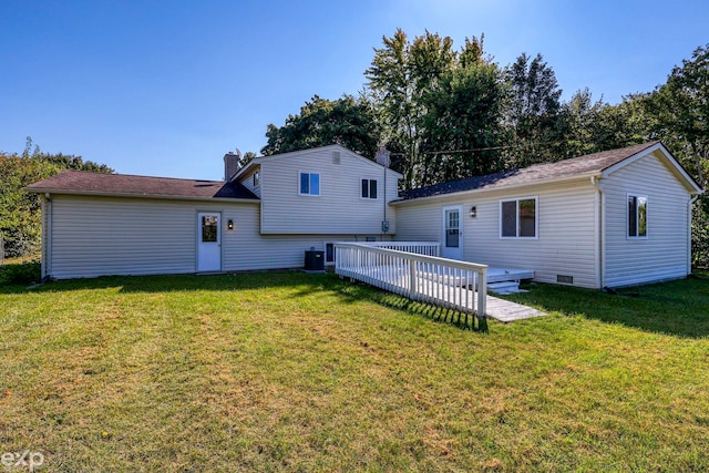 back of house featuring central AC, a lawn, and a wooden deck